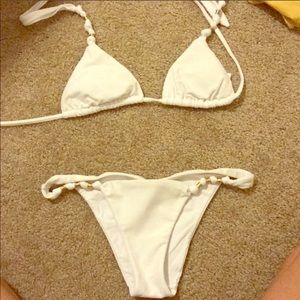 White VIX bathing suit with gold ring.